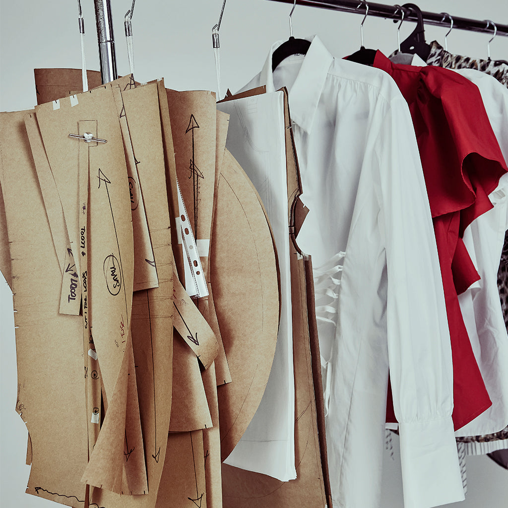 Realm Origin design studio showing shirt patterns and shirt samples, representing the brand's commitment to Australia-made craftsmanship and refined shirting design.