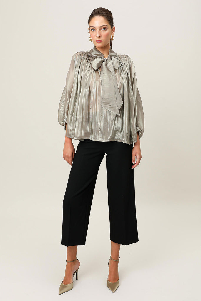 E-commerce front image of the Realm Origin Atelier Bow Top in semi-sheer satin with adjustable bow tie, shoulder panel piping and voluminous 3/4 sleeves.