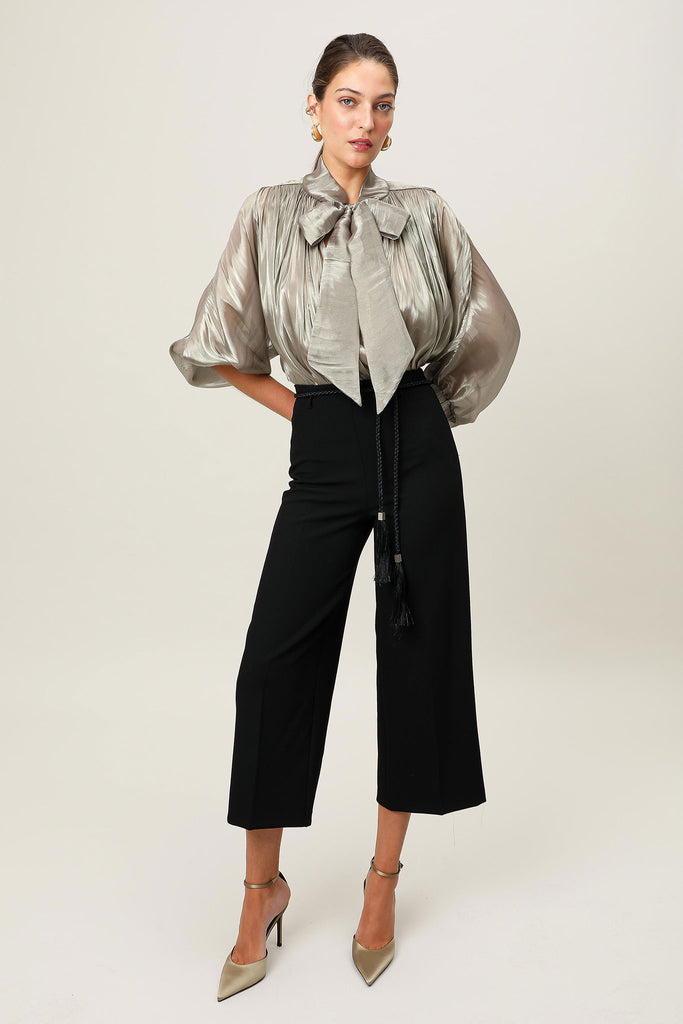 E-commerce image of the Realm Origin Atelier Bow Top tucked in, showcasing Japanese satin, adjustable bow tie neckline, shoulder panel piping and gathered bodice.
