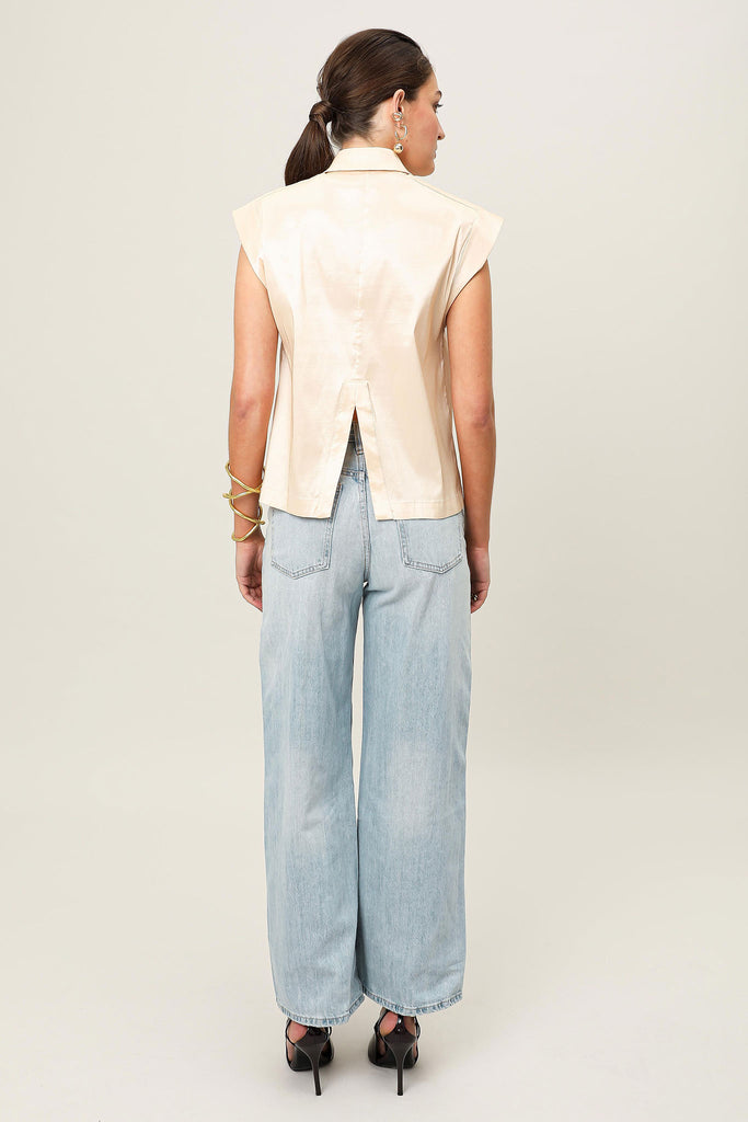 E-commerce back profile of the Realm Origin Sol Verite Shirt in poweder beige taffeta, structured sleeveless shirt featuring step hem, back vent and taillored shoulder line, worn on-model.